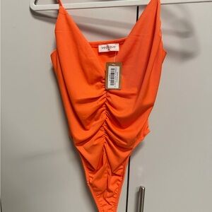 NWT Medium Vestique Bright Orange bodysuit